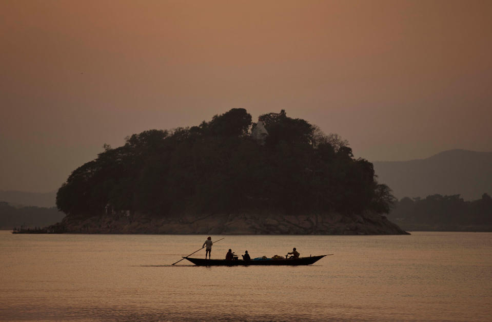 A fishermen rows a boat in Gauhati, India