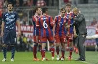 Pep Guardiola (right) with ripped trousers gives his players instructions during the Champions League quarter-final second-leg against FC Porto in Munich on April 21, 2015