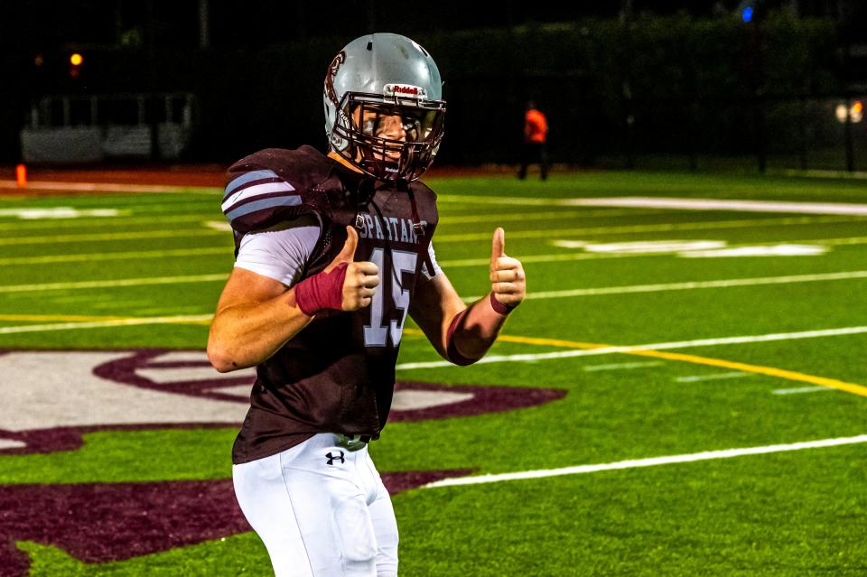 Bishop Stang's Michael Golden gives the thumbs up after the Spartans' season opener.