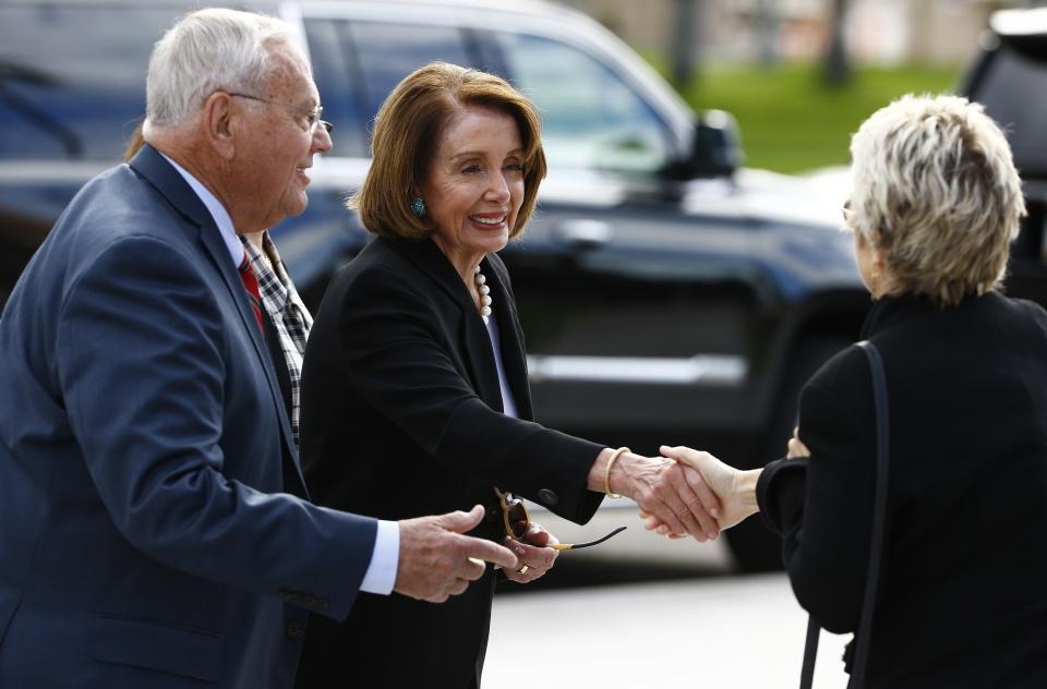 Rep. Nancy Pelosi, D-Calif., middle, and former Rep. Harry Mitchell, D-Ariz., left, shake hands with another person as they arrive for the funeral of former Democratic U.S. Rep. Ed Pastor Friday, Dec. 7, 2018, in Phoenix. Pastor was Arizona's first Hispanic member of Congress, spending 23 years in Congress before retiring in 2014. Pastor passed away last week at the age of 75. (AP Photo/Ross D. Franklin)