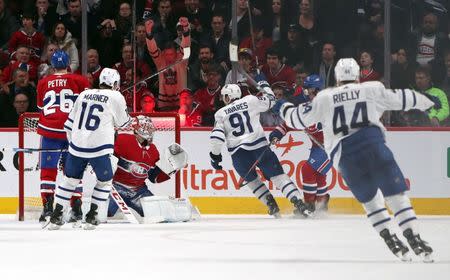 Feb 9, 2019; Montreal, Quebec, CAN; Toronto Maple Leafs center John Tavares (91) celebrates his goal against Montreal Canadiens goaltender Carey Price (31) with teammates during an over time period at Bell Centre. Mandatory Credit: Jean-Yves Ahern-USA TODAY Sports