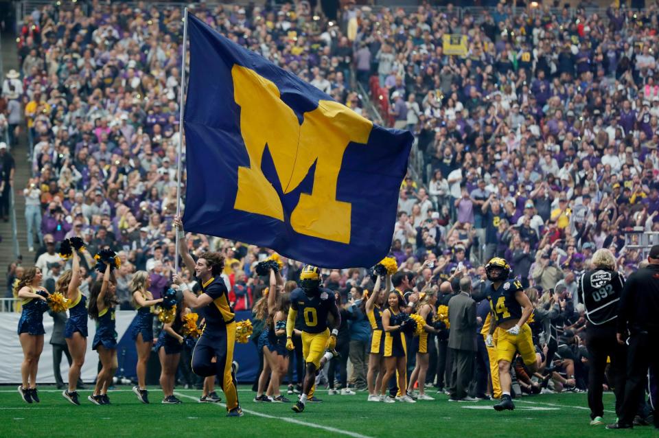 The Michigan football team takes the field at the start of the Fiesta Bowl against TCU on Dec. 31 at State Farm Stadium in Glendale, Ariz.