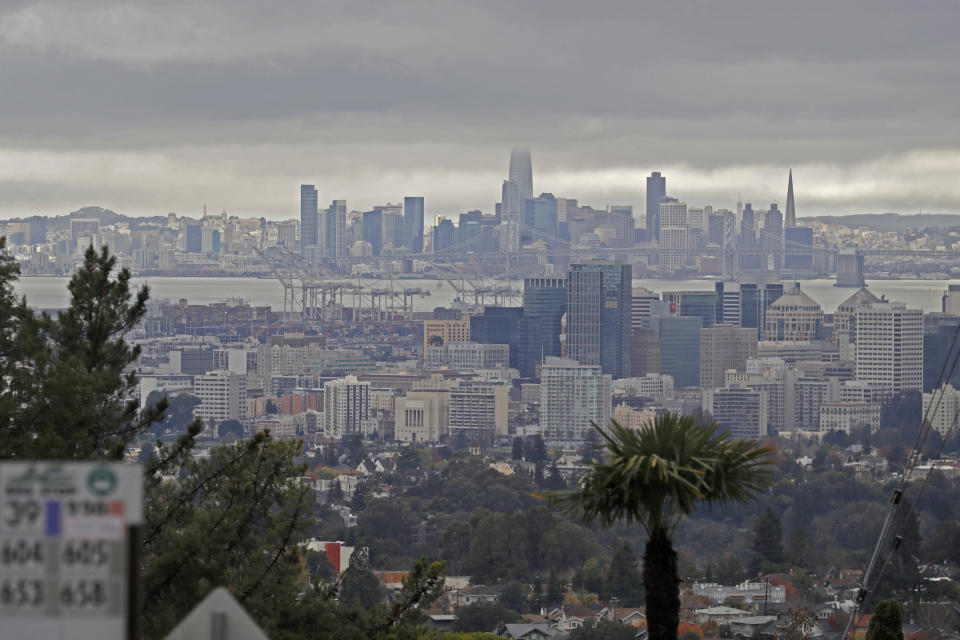Storm clouds are seen over San Francisco in this view from Oakland, Calif., on Thursday, Dec. 23, 2021. Heavy overnight rains in Northern California left two people dead in a submerged car as authorities on Thursday urged residents of several Southern California mountain and canyon communities to voluntarily leave their homes because of possible mud and debris flows. (Jane Tyska/Bay Area News Group via AP)