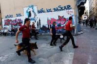 Police officers with dogs chase LGBT rights activists as they try to gather for a pride parade, which was banned by the governorship, in central Istanbul, Turkey, June 25, 2017. REUTERS/Murad Sezer