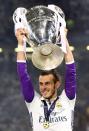 <p>Real Madrid’s Gareth Bale celebrates with the trophy after winning the UEFA Champions League Final </p>