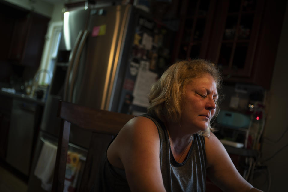 Susan Ryder sits quietly at the breakfast table as she recounts the emotional times of not being able to see her mother during the shut down of nursing homes which stopped her from being able to visit her mother because of COVID, Monday, Nov. 29, 2021, in Rotterdam Junction, N.Y. (AP Photo/Wong Maye-E)