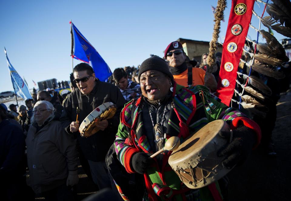 FILE - In this Dec 4, 2016, file photo, Dan Nanamkin, of the Colville Nez Perce Native American tribe in Nespelem, Wash., right, drums with a procession through the Oceti Sakowin camp after it was announced that the U.S. Army Corps of Engineers won't grant easement for the Dakota Access oil pipeline in Cannon Ball, N.D. Some Native Americans worry the transition to a Donald Trump administration signals an end to eight years of sweeping Indian Country policy reforms. Trump rarely acknowledged Native Americans during his campaign. And he hasn't publicly outlined since the election how he would improve or manage the United States' longstanding relationships with tribes. But Trump's Native American supporters said they're hopeful he will cut through some of the government red tape that they believe has stifled economic progress on reservations. (AP Photo/David Goldman, File)