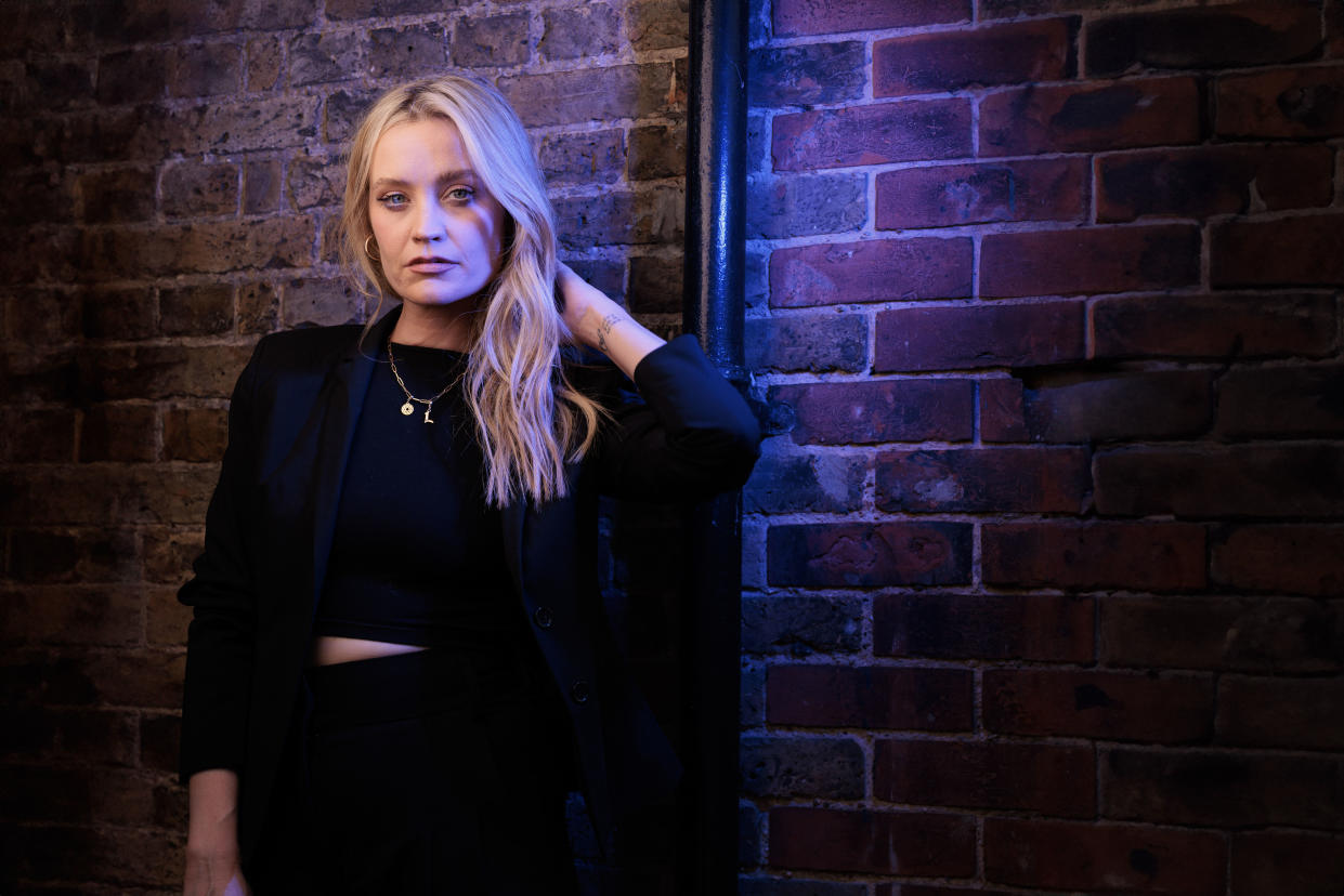 Laura Whitore poses to promter her show LAURA WHITMORE INVESTIGATES