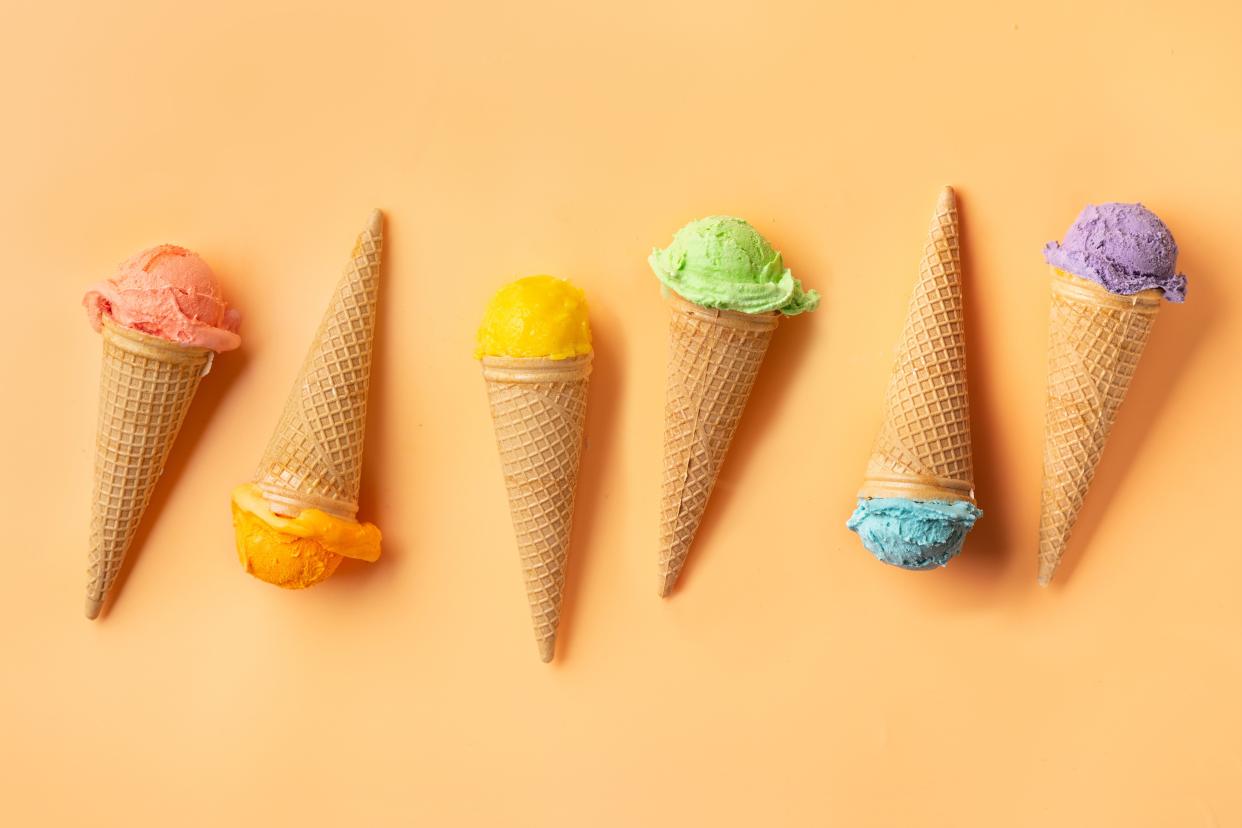 Colorful ice cream cones on yellow backgound. Summer concept