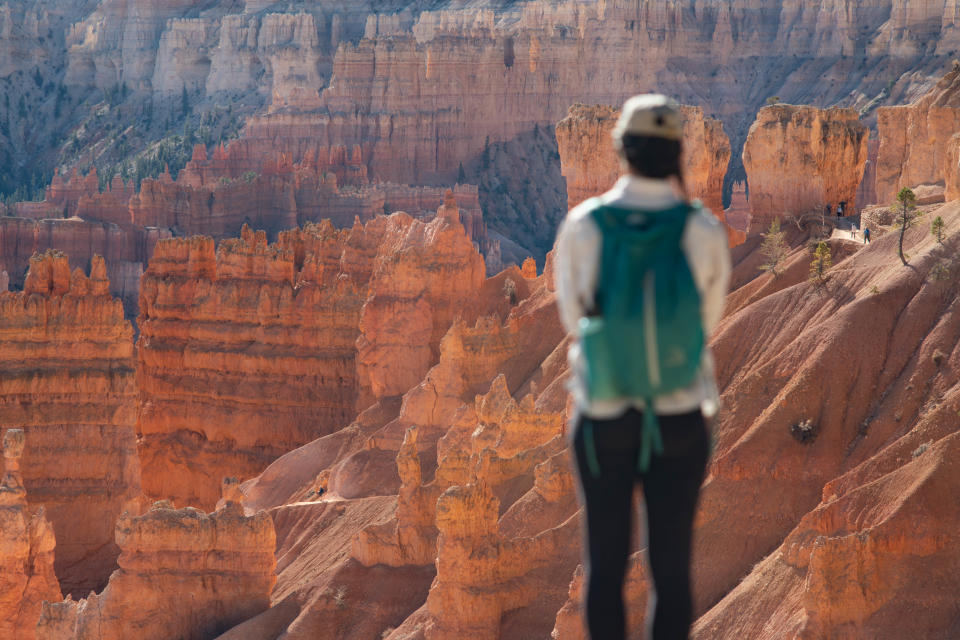 A visitor stops to take in the view of the hoodoos along Bryce Canyon's Rim Trail.