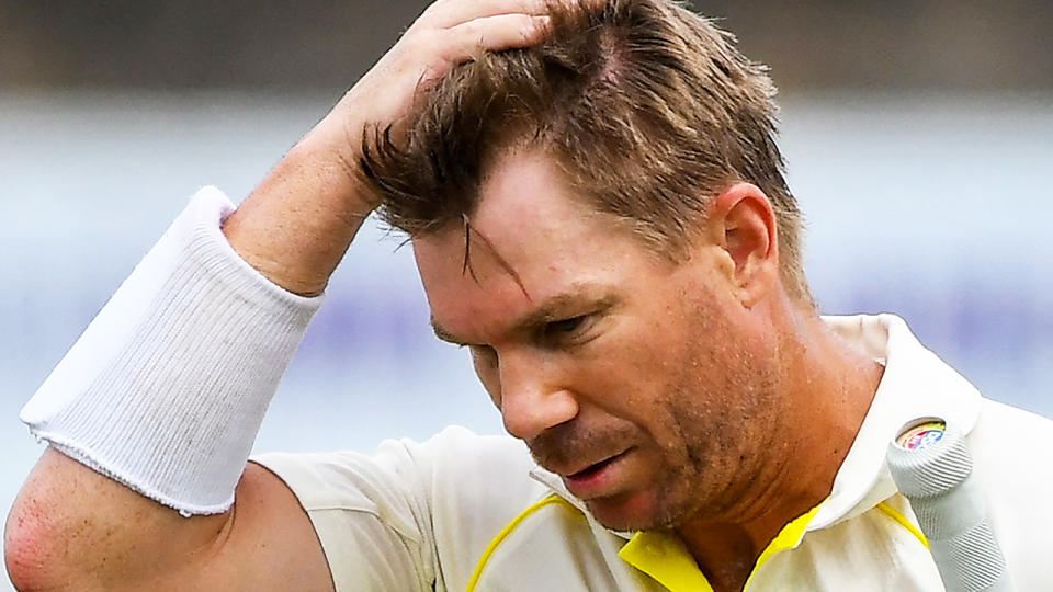 David Warner walks from the field after losing his wicket.