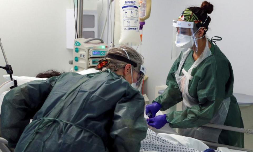 Nurses care for a patient in an Intensive Care ward treating victims of the coronavirus disease.