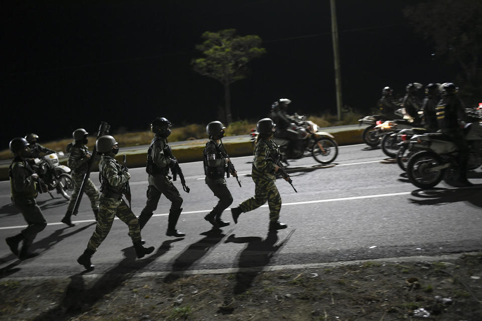 Security forces take part in a military drill to mark the eighth death anniversary of President Hugo Chavez in Caracas, Venezuela, late Friday, March 5, 2021. (AP Photo/Matias Delacroix)