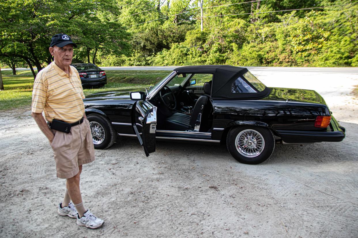Ben St. John stands beside his '78 Mercedes.