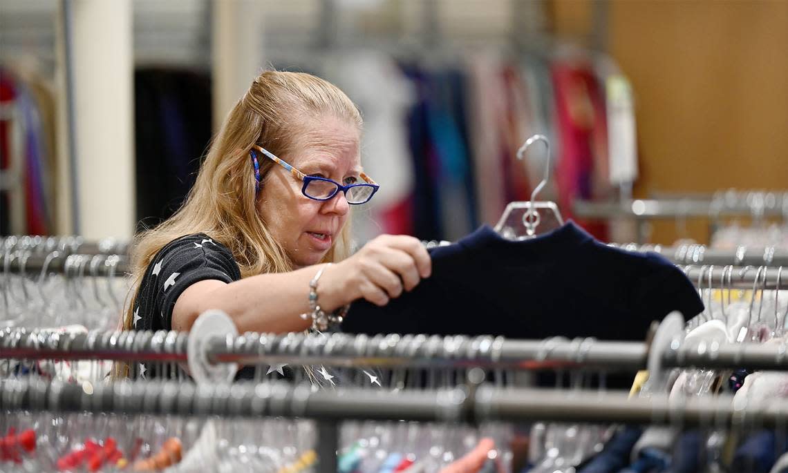 Darlene Sharp looks at clothing at The Salvation Army Family Thrift Store and Donation Center on McHenry Avenue in Modesto, Calif., Thursday, Oct. 6, 2022. The center reopened four months after a fire shuttered the Modesto business.