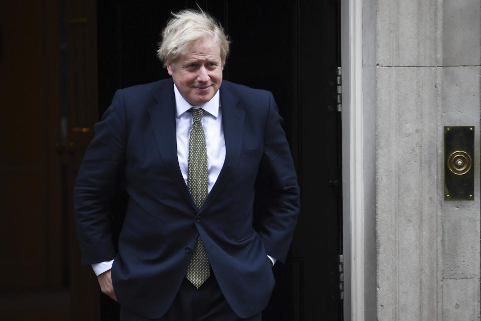 Britain's Prime Minister Boris Johnson steps outside 10 Downing Street, in London, to welcome Egypt's President Abdel Fattah el-Sisi on Tuesday, Jan. 21, 2020. (AP Photo/Alberto Pezzali)