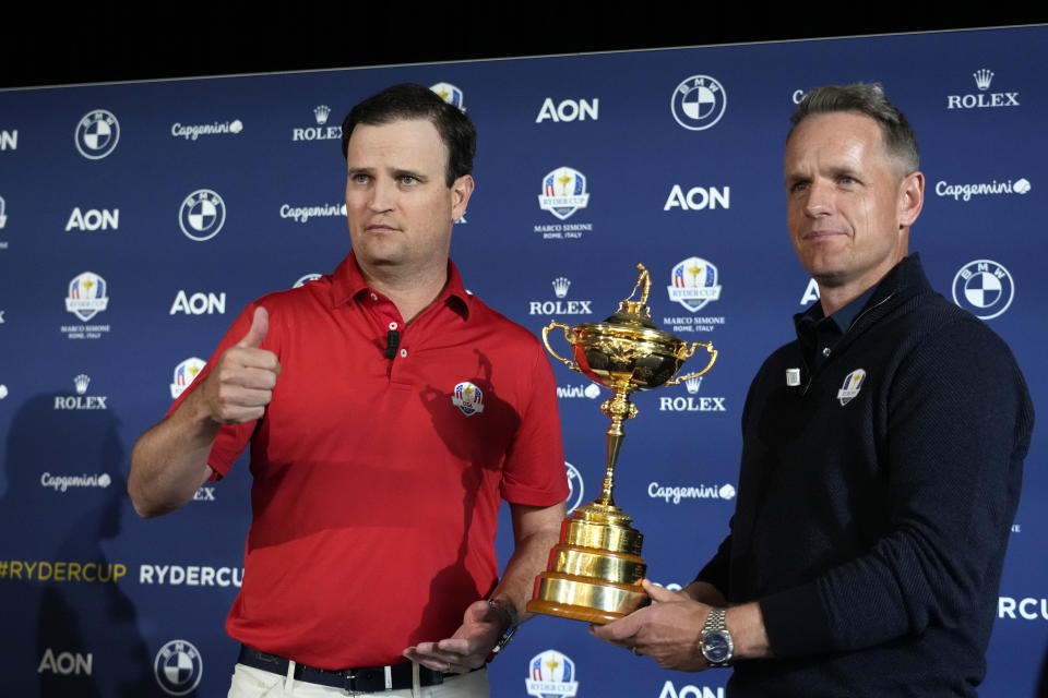 United States Captain Zach Johnson, left, and European Captain Luke Donald pose with the Ryder Cup trophy after a press conference on the occasion of The Year to Go event in Rome, Tuesday, Oct. 4, 2022. (AP Photo/Alessandra Tarantino)