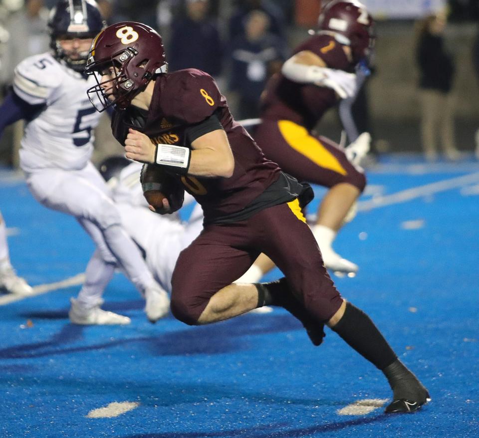 Walsh Jesuit quarterback Keller Moten takes off on a long touchdown run during a regional semifinal vs. Hudson on Friday in Ravenna.