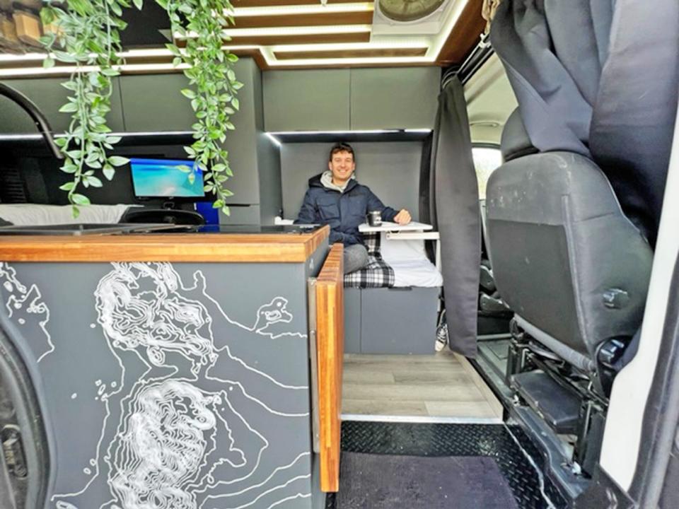 Twomey sits inside his van home.