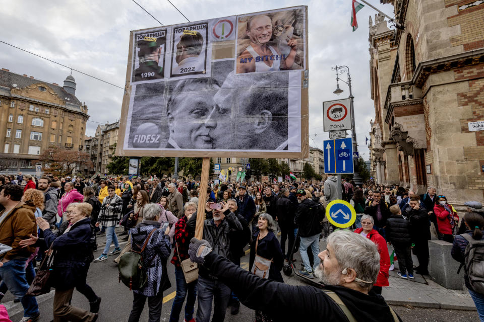 A banner at a protest march shows Orbán with Putin.