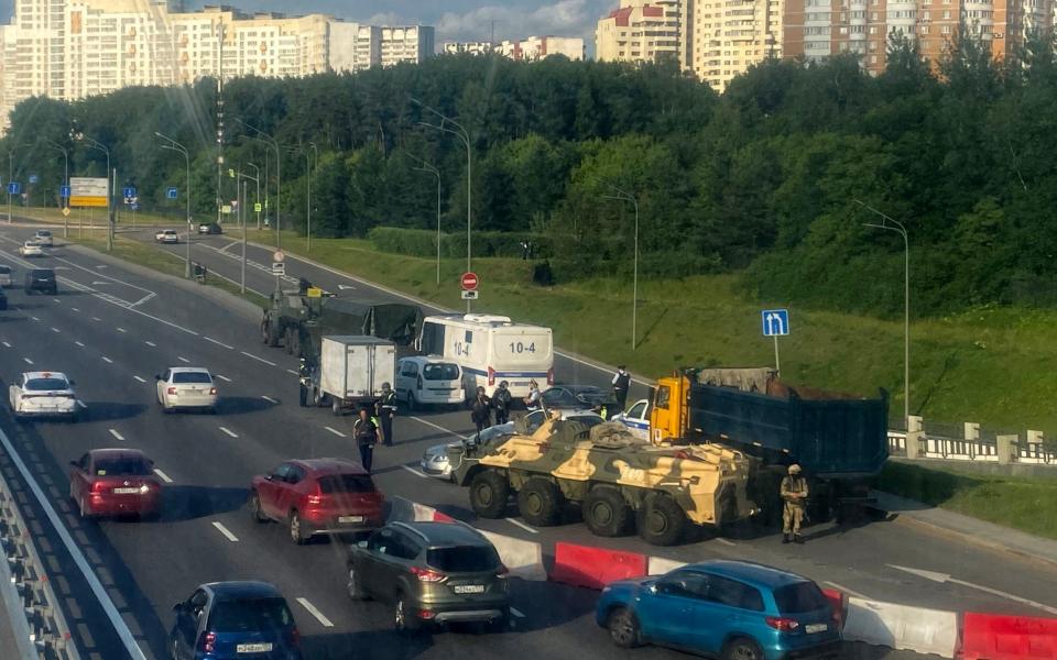 Russian police officers, traffic police officers and servicemen block part of a highway entering Moscow on June 24, 2023. Moscow mayor Sergei Sobyanin on June 24, 2023 warned the situation in the capital was "difficult," as forces of the Wagner mercenary group moved towards Moscow to oust Russia's military leadership. (Photo by AFP) (Photo by -/AFP via Getty Images)