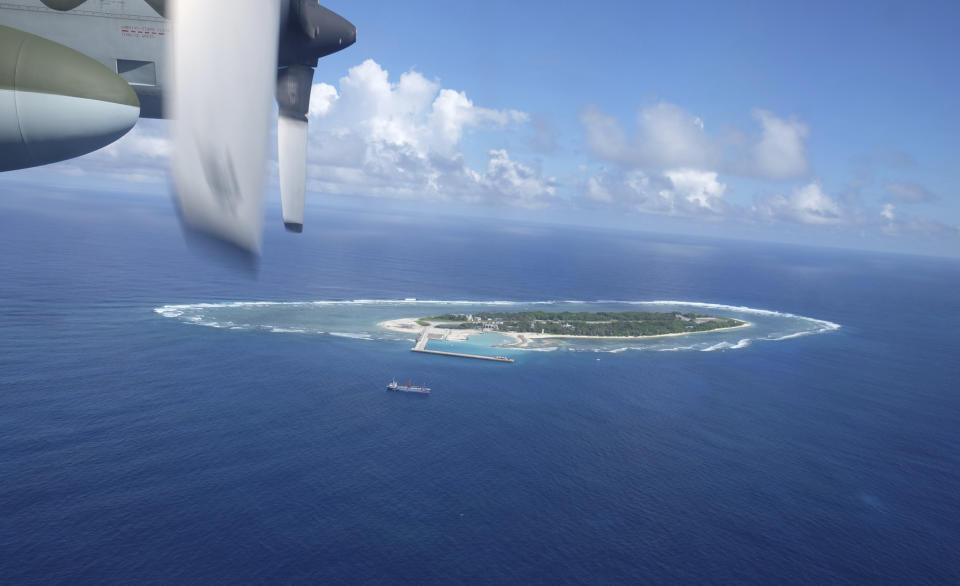 An aerial view shows a vessel preparing for a search-and-rescue exercise off Taiping island, in the South China Sea , Tuesday, Nov. 29, 2016, as part of efforts to cement its claim to a key island in the strategically vital waterbody. Eight vessels and three aircraft took part in Tuesday's drill, which simulated a fire aboard a cargo ship that forced crew members to seek safety on Taiping in the Spratly island group. (AP Photo/Johnson Lai)