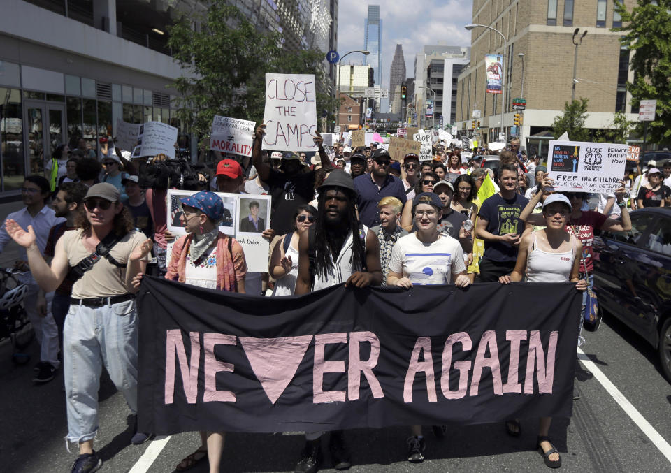 FILE - In this July 4, 2019, file photo, protesters assembled by a majority Jewish group called Never Again Is Now walk through traffic as they make their way to Independence Mall in Philadelphia. A fledgling coalition of liberal Jewish groups is increasingly making itself heard as it fights the Trump administration’s immigration policies. (AP Photo/Jacqueline Larma, File)