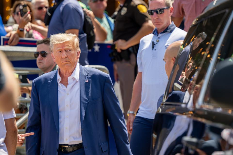 Republican presidential candidate and former U.S. President Donald Trump is directed to his vehicle after speaking at the Steer N' Stein bar at the Iowa State Fair (Getty Images)