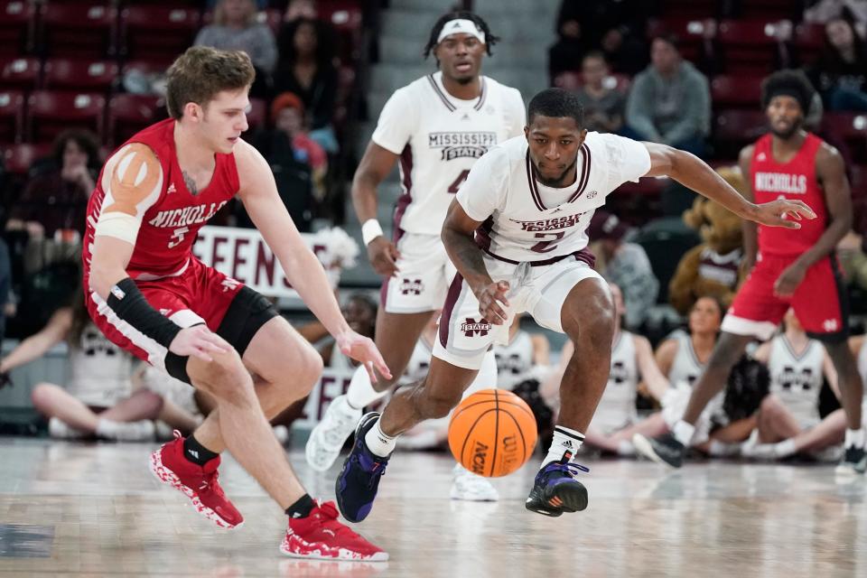 Nicholls State guard Pierce Spencer (5) and Mississippi State guard Jamel Horton Jr. (2) lunge for a loose ball during the first half of an NCAA college basketball game, in Starkville, Miss., Saturday, Dec. 17, 2022. Mississippi State won 68-66. (AP Photo/Rogelio V. Solis)