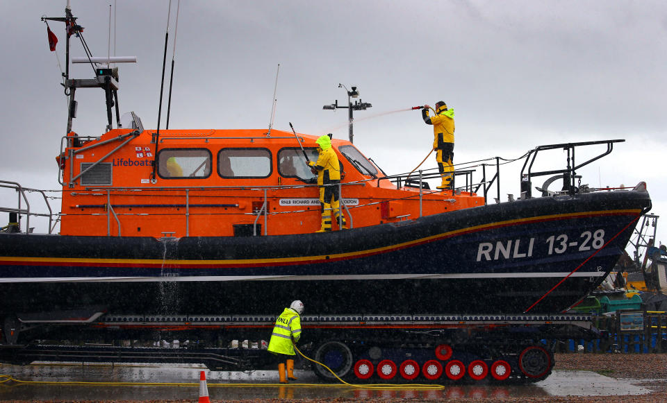 The Hastings Shannon Class lifeboat is washed down by crew members following a training exercise in Hastings, East Sussex.