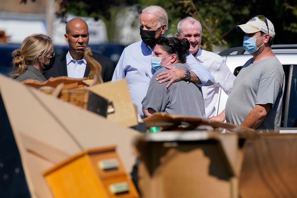 President Joe Biden tours a neighborhood hit by Hurricane Ida on Sept. 7 in Manville, N.J., accompanied by Sen. Cory Booker, D-N.J., second from left, and New Jersey Gov. Phil Murphy, second from right.