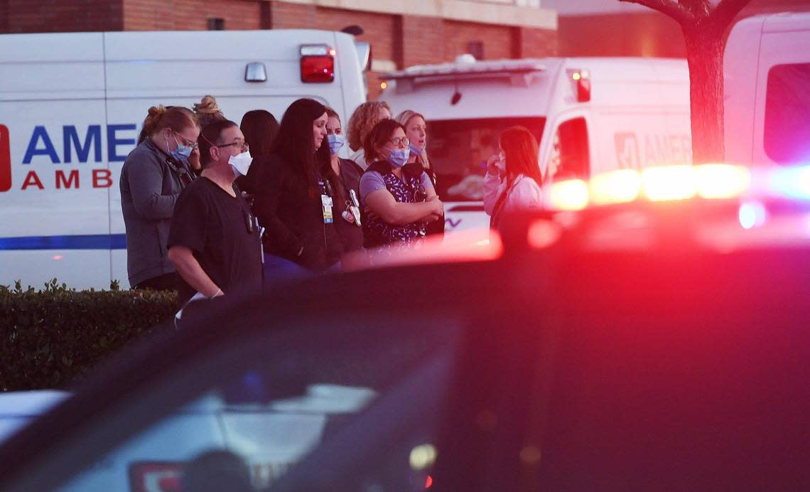 Hospital staff wait to watch as a procession lines up outside Community Regional Medical Center in Fresno for the Selma police officer who was shot and killed earlier Tuesday afternoon, Jan. 31, 2023 in Selma.