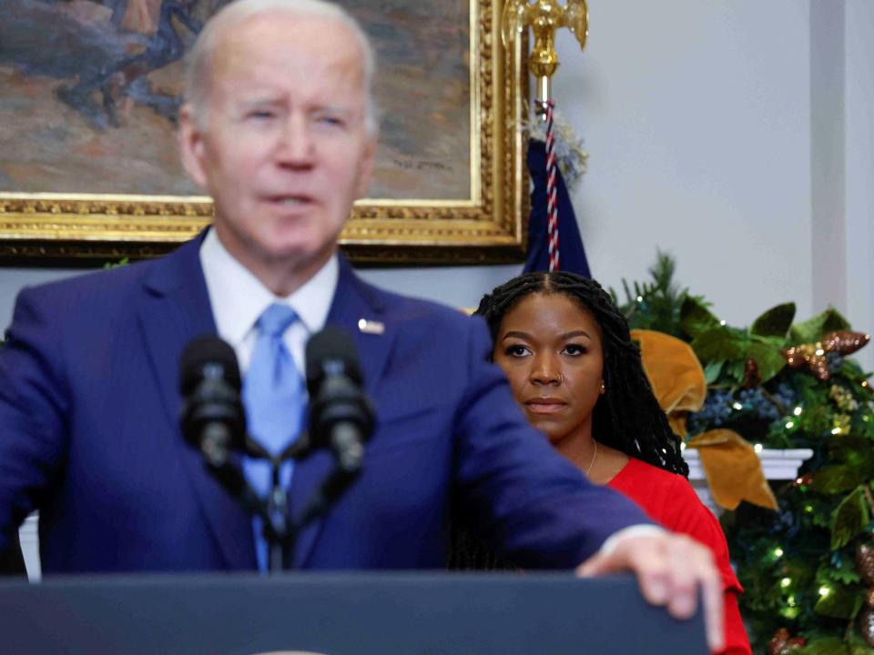 President Joe Biden addresses the press as Griner's wife, Cherelle, looks on.