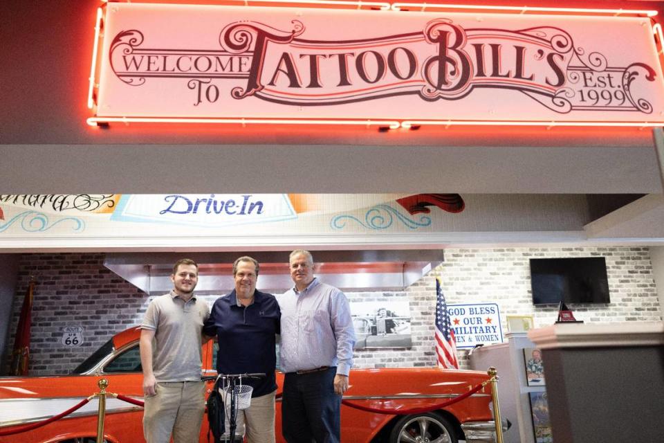 From left, Stewart Thigpen, Kenny Thigpen and Frank Thigpen, who run Tattoo Bill’s in Charlotte, stand Wednesday near their late father’s car in the shop at 10823 John Price Road.