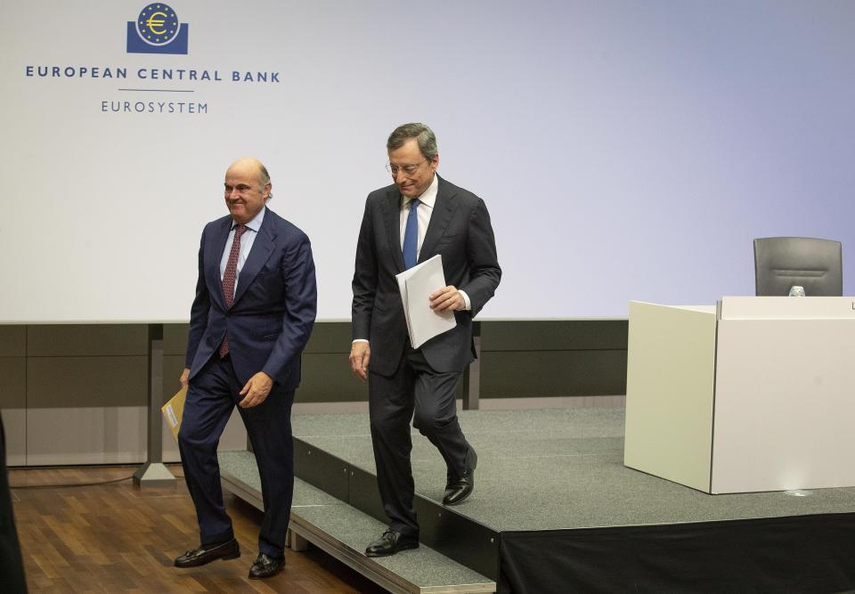 President of European Central Bank Mario Draghi, right, and Vice President Luis de Guindo leave the podium after a press conference after Draghi chaired his last policy meeting in Frankfurt, Germany, Thursday, Oct. 24, 2019. (AP Photo/Michael Probst)