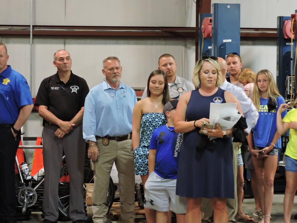 Miranda Conner Ellington presents scholarships in memory of her late husband State Trooper Kevin Conner on June 16, 2021, while then-sheriff of Columbus County, Jody Greene, looks on.