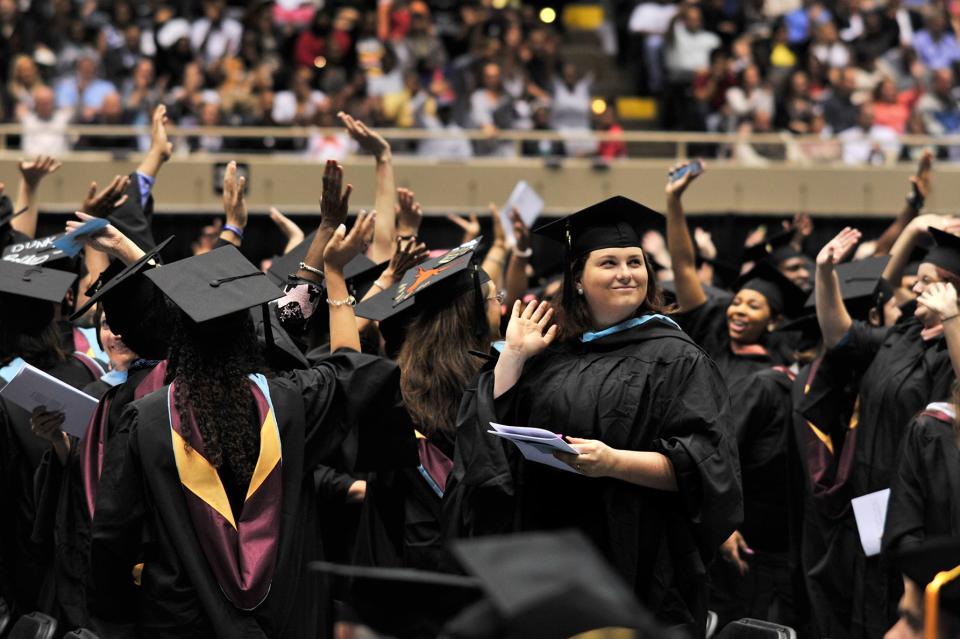 Joseph Jacob/ Savannah Morning NewsGraduating students of Armstrong Atlantic State University wave to their parents after commencement speaker, Regent Larry Ellis, tells the graduates to thank their parents for supporting and providing for them.