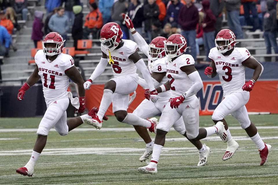Players with the Rutgers defensive unit celebrate stopping Illinois on a fourth and one late in the second half of an NCAA college football game Saturday, Oct. 30, 2021, in Champaign, Ill. Rutgers won 20-14. (AP Photo/Charles Rex Arbogast)