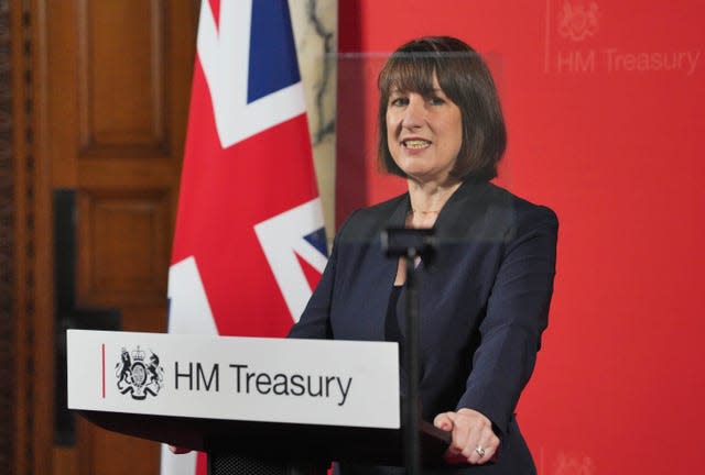 Rachel Reeves giving a speech at a lectern with a HM Treasury sign