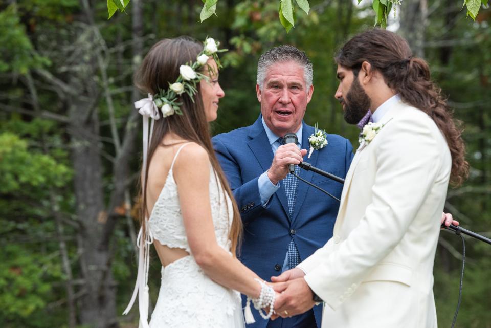 An officiant marries Anthony and Kelly Anne Ferraro at their wedding.