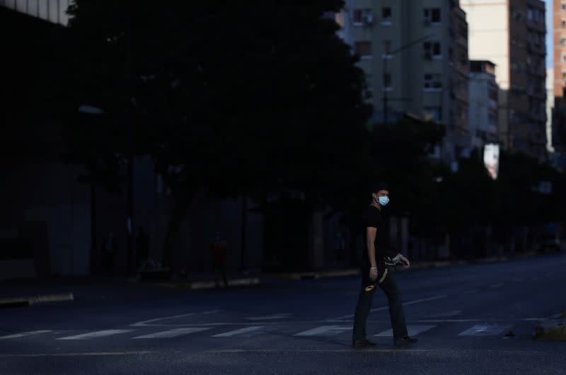A person wearing a protective mask on the streets after the start of quarantine in response to the spread of coronavirus disease (COVID-19) in Caracas
