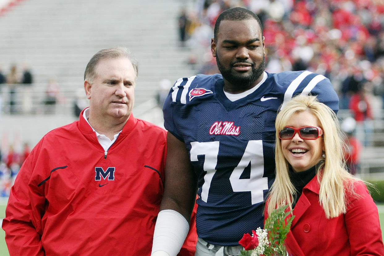 Michael Oher and Sean and Leigh Anne Tuohy on the field (Matthew Sharpe / Getty Images file)