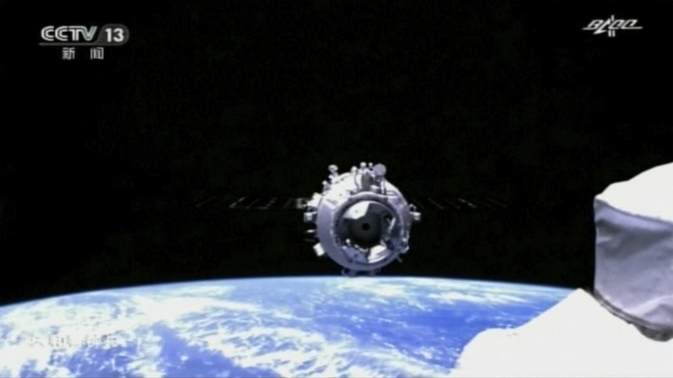 In this image taken from video footage run by China's CCTV, the docking process in space between the Tianhe core module of China's space station and a Shenzhou-12 spaceship carrying a crew of Chinese astronauts is seen, Thursday, June 17, 2021. A Chinese spaceship carrying a three-person crew has docked with China's new space station at the start of 3-month mission, marking a milestone in the country's ambitious space program. (CCTV via AP Video)