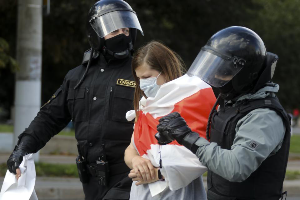 Riot police officers detain a protester during a Belarusian opposition supporters' rally protesting the official presidential election results in Minsk, Belarus, Sunday, Sept. 13, 2020. More than 100,000 demonstrators calling for the authoritarian president's resignation marched in the Belarusian capital on Sunday as the daily protests that have gripped the nation entered their sixth week. (AP Photo)