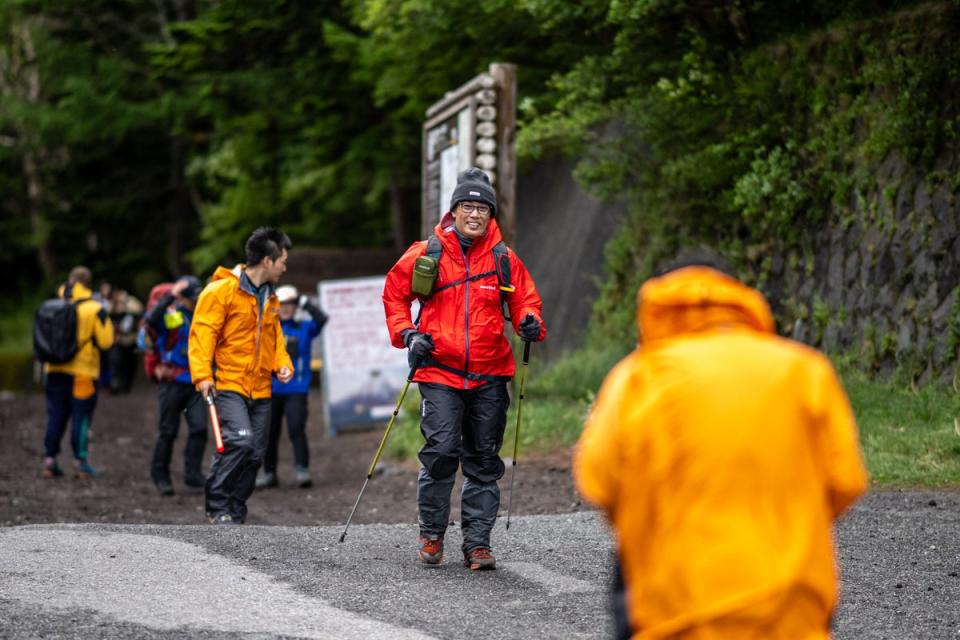 Hikers walk out from the newly installed gate at Fuji Subaru Line 5th station on their way to Mount Fuji on the first day of the new climbing season at Narusawa in Yamanashi prefecture (AFP via Getty)