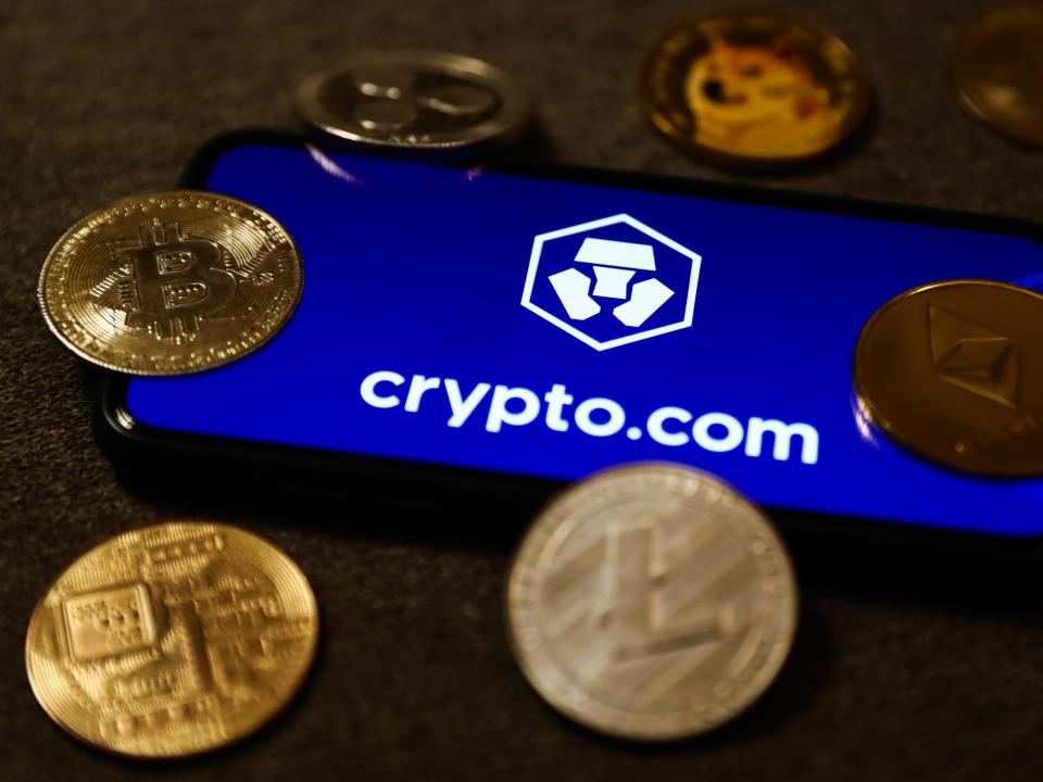 Crypto.com logo displayed on a phone screen and representation of cryptocurrencies are seen in this illustration photo taken in Krakow, Poland on September 28, 2021.