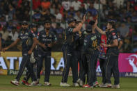 Gujarat Titans players celebrates the dismissal of Royal Challengers Bengaluru's Rajat Patidar during the Indian Premier League cricket match between Royal Challengers Bengaluru and Gujarat Titans in Bengaluru, India, Saturday, May 4, 2024. (AP Photo)