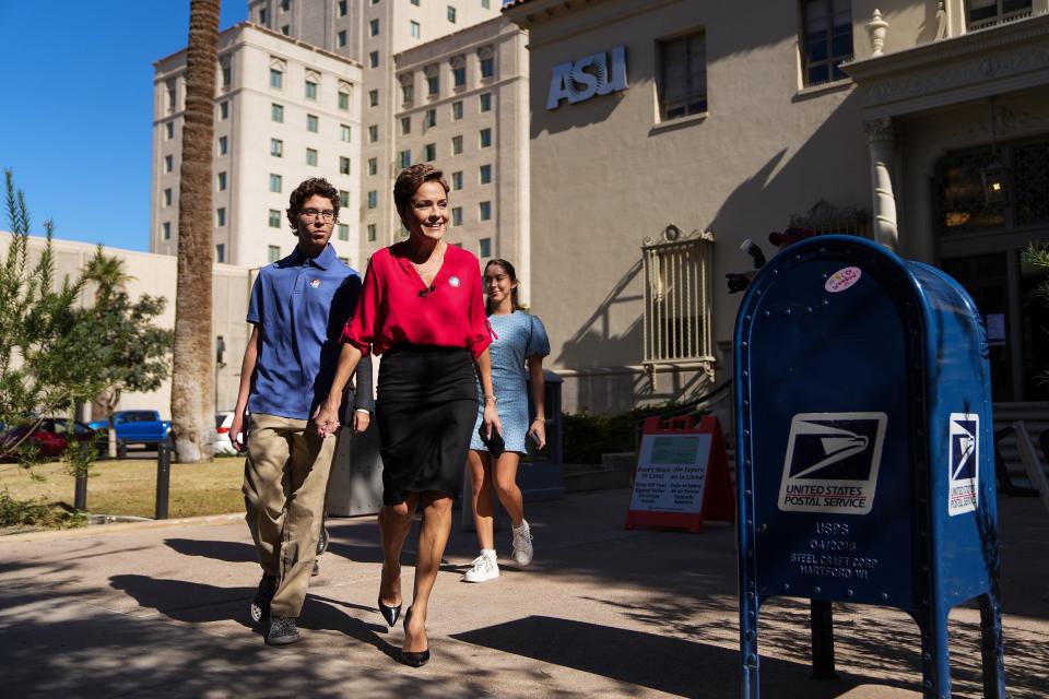 Kari Lake, candidate for Arizona Governor, exits a post office on First Avenue with her son and daughter after casting her vote on Tuesday, Nov. 8, 2022, in downtown Phoenix.