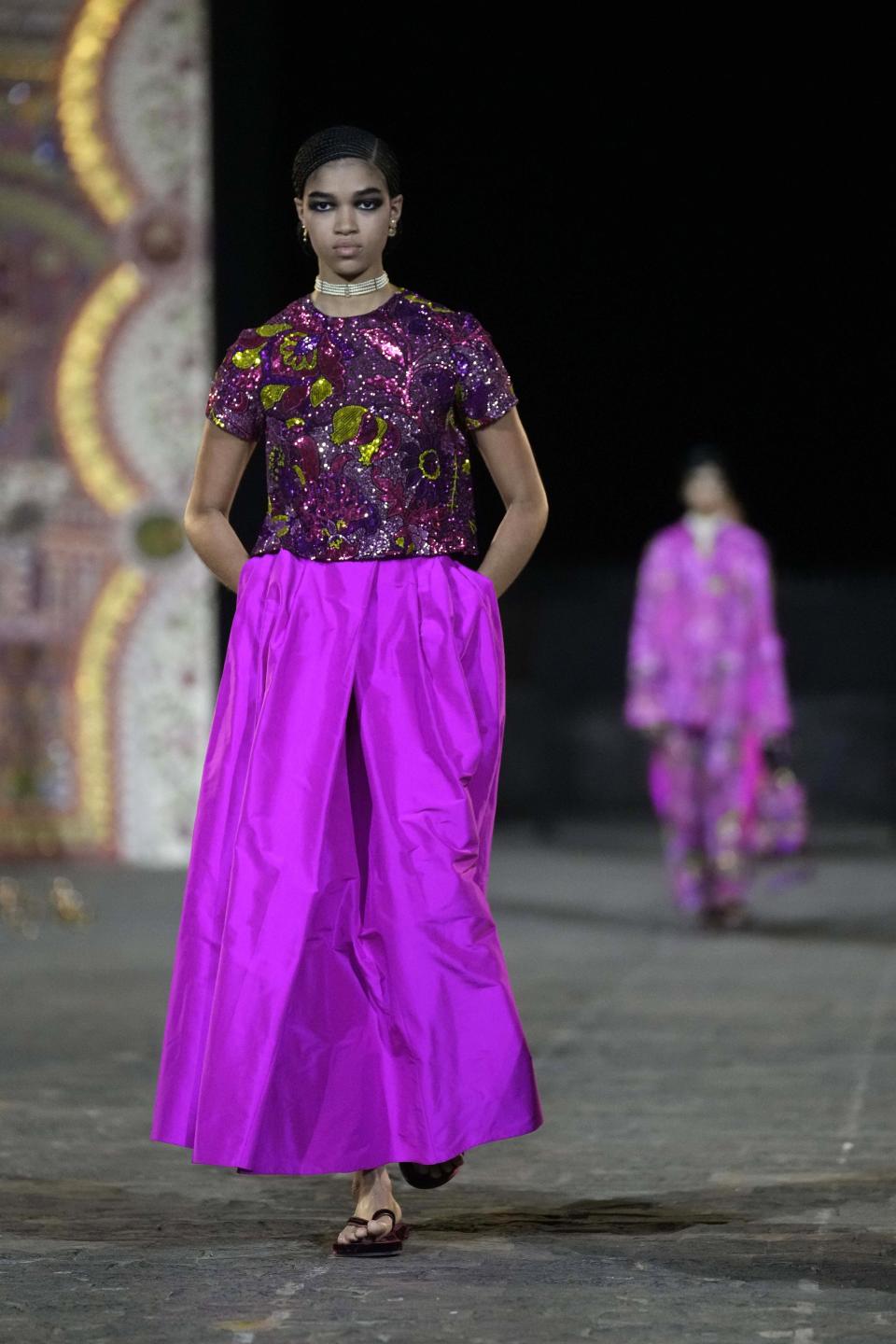 A model wears a creation for the Dior Pre-Fall 2023 collection at the Gateway of India landmark monument in Mumbai, India, Thursday, March 30, 2023. (AP Photo/Rafiq Maqbool)