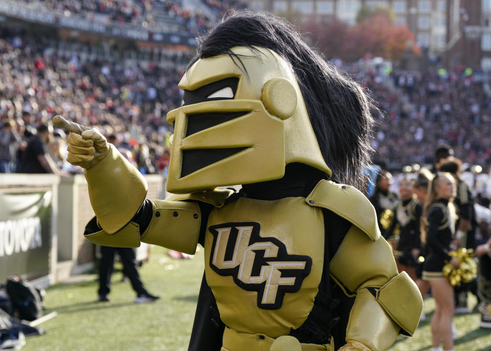 Central Florida mascot Knightro gestures during the first half of an NCAA college football game against Cincinnati, Saturday, Nov. 4, 2023, in Cincinnati. (AP Photo/Jeff Dean)